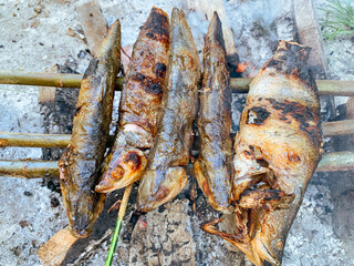 Grilled milkfish over charcoal.