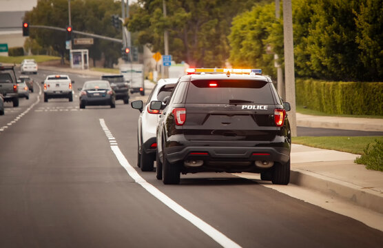 Behind view of a police car that pulled a motorist over to the side of the road
