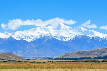 Fototapeta premium A peaceful scene of cattle grazing in a lush green field with rolling hills and blue sky