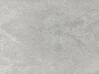 A grey cement wall with a lot of texture. Stucco background