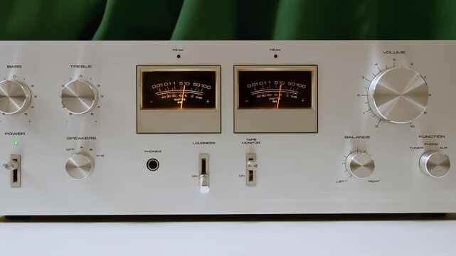 Vintage hi-fi stereo amplifier with power output meters and aluminum knobs