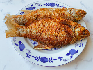 Fried Kendia fish or Thynnichthys on a plate