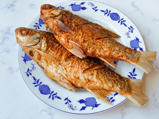 Fried Kendia fish or Thynnichthys on a plate