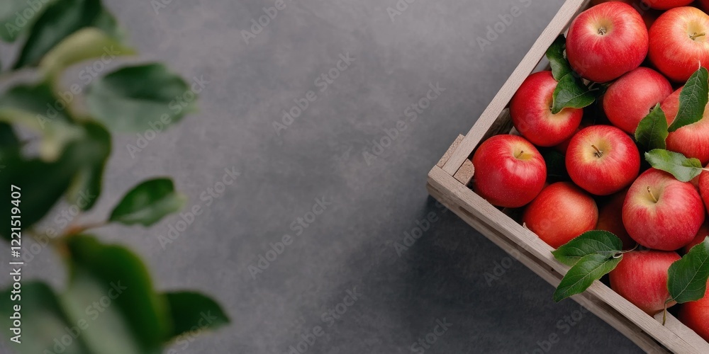 Poster freshly harvested apples fill a rustic wooden crate with one apple slightly offset outside of the cr