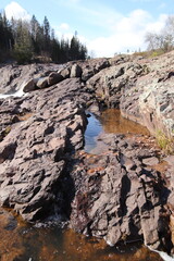 Rocky rapids near a waterfall in the spring in a Minnesota state park