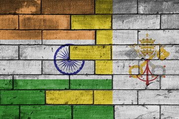 colourful painted big flag of india and flag of vatican city on a massive old brick wall background. concept