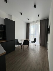 Minimalist dining area with modern furniture and natural light from large windows
