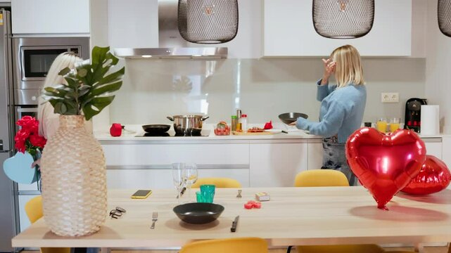 Women preparing romantic dinner surprise for valentine's day