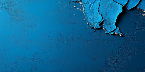 Textured blue wall with peeling paint revealing layers underneath, showcasing an artistic decay in a modern interior