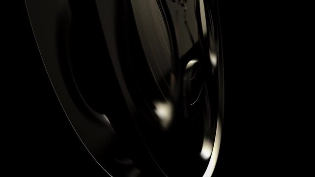 Movie tape, graphics composition detail element. Reel tape spool rolling in a dark classic cinema concept. CG close up shot, ideal for movie show intros, logos or transitions