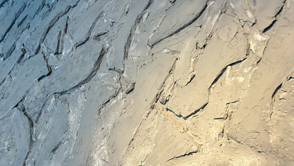 Abstract Textured Wall Surface with a Stucco Finish in Muted Earth Tones. Perfect for Interior Design, Backgrounds, or Artistic Inspirations Highlighting Modern Rustic Aesthetics.