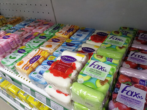 Variety of soap bars on shelf in supermarket aisle