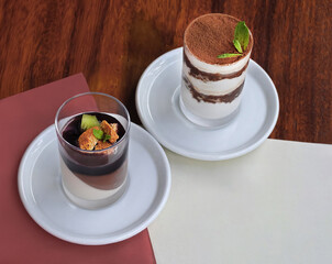 Delicious tiramisu and panacota desserts served on elegant plates