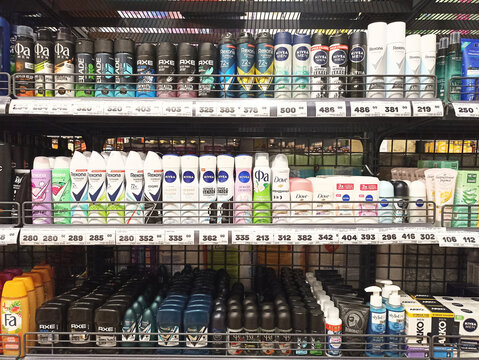 Supermarket shelf displaying various deodorants and personal care products