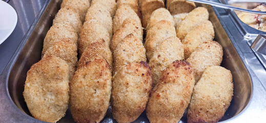 Savory fried dumplings arranged in a tray at a festive gathering