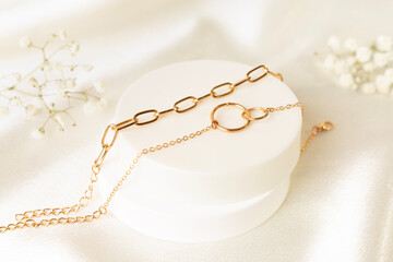 Golden earrings with decor on textile background