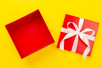 Open red gift box on color background, top view