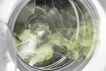 Modern washing machine with empty drum, closeup