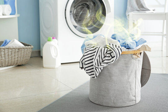 Basket with dirty laundry on floor in bathroom