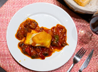 Delicious stewed cod served with samfaina vegetables served in restaurant