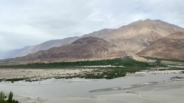 View of beautiful Himalayan mountains and sand dunes at Khalsar with the longest high-altitude zipline in Nubra Valley in the Himalayas. Ladakh, India.