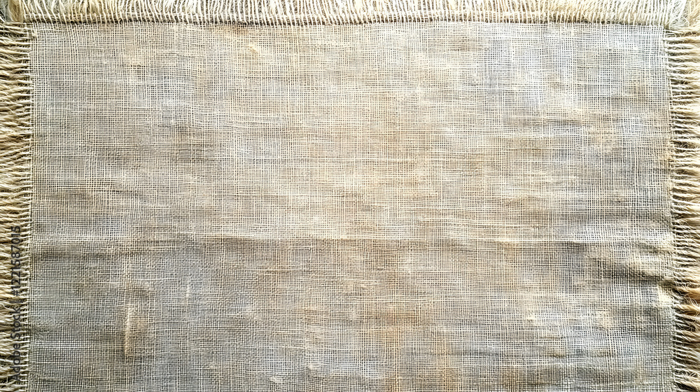 Poster piece of cloth with fringes displayed on a neutral background for textile and fabric design
