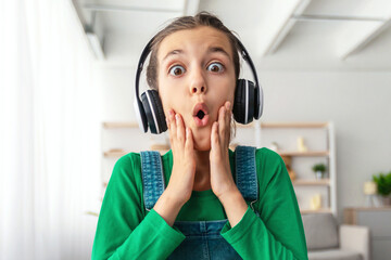 Wow. Portrait of young surprised girl looking at screen with open mouth in amazement, reading news...