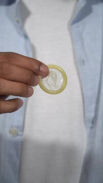 Man taking condom out of wrapper