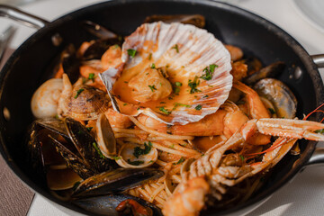 Seafood. Seafood pasta in a frying pan. Close-up.