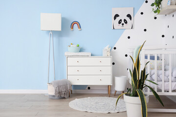 Obraz premium Stylish interior of modern baby's room with chest of drawers and bed