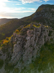 Fototapeta premium Epic aerial view of the historic Haj-Nehaj fortress on a mountain peak, scenic hiking destination and medieval ruins in Montenegro, 4K drone