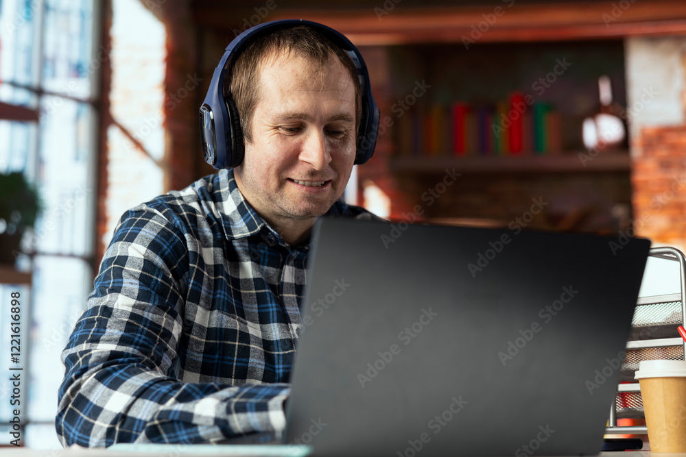 Aufkleber smiling employee at work watching comical videos on social media using laptop. relaxed jolly employe