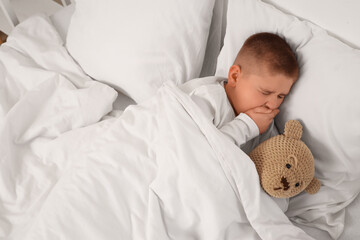 Sick little boy in bed