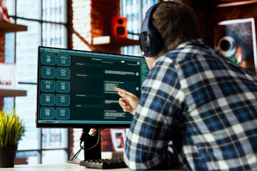 Man wearing headphones in home office uses AI LLM chatbots designed to understand human language....