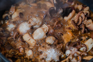 Seafood. Octopus is fried in a frying pan. Close-up.