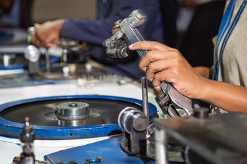 Polishing wheel in a diamond factory in Botswana, showcasing an African worker's hands polishing a...