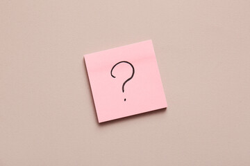 Sticky note with question mark on color background