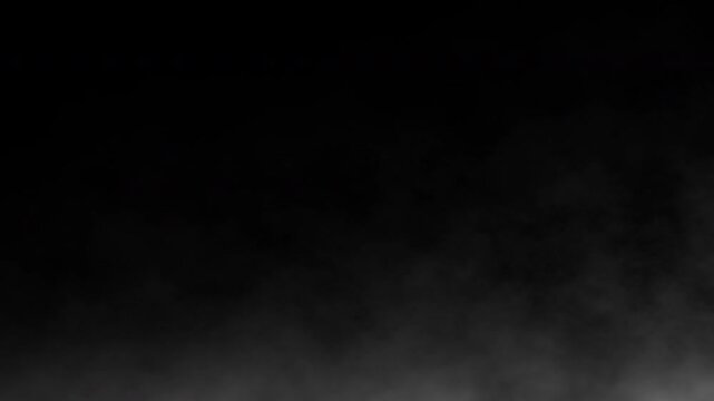 White smoke floating on the ground against a black background. Fog effect. 4k animation