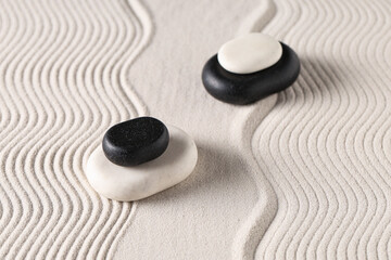 Stones on white sand with lines. Yin Yang concept