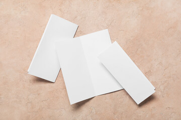 Blank brochures on beige background