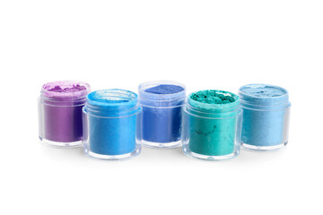 Jars with different colorful powder pigments on white background