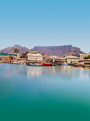 Fototapeta premium Victoria and Alfred Waterfront with Table Mountain in the background and a clear blue sky, South Africa