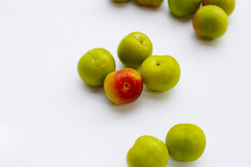 Fresh green plum on white background