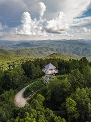 Wooden Fire Lookout Tower Surrounded by Forested Hills with Expansive Views