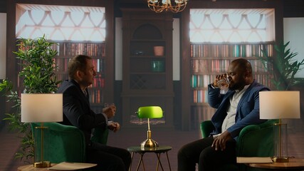 Businessmen in a classy library discuss partnership goals over whiskey, reflecting trust, success...