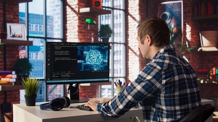 Teleworking programmer using computer for artificial intelligence computing through self learning algorithms. Remote worker working with AI deep neural networks on desktop PC, camera A