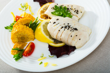 Cod of 250 grams prepared in frying pan in water with olive oil for 10 minutes. Add salt, pepper. Served with boiled corn, greens and lemon at plate
