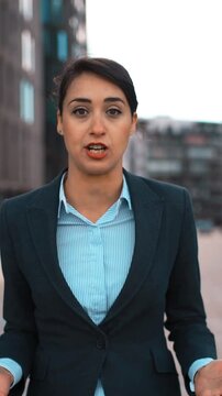 POV. Portrait of young attractive sexy caucasian businesswoman Swear and cuss on You. Pomade, brownhair, lady. Negation concept. Blackguard abuse. Formal suit. Modern glass buildings bg. Sunrise. Teal