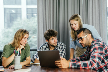 Group of young people working together. Creative business people in modern office