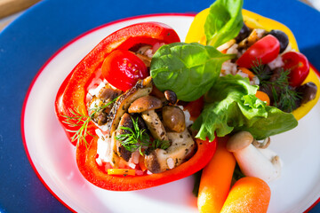 Fresh sweet peppers stuffed with wild mushrooms, rice with sesame seeds, herbs and vegetables